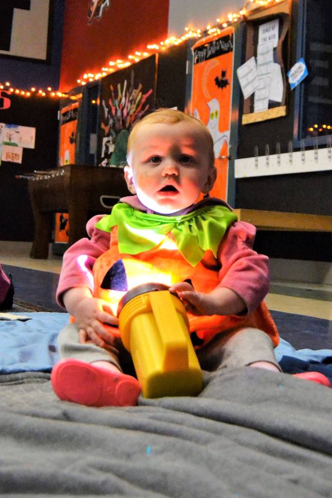 Alice Marie Michael, 1, of Sequim, enjoys the atmosphere of the Sequim Boys & Girls Club as she plays with a flashlight.