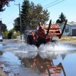 In 2018, staff with the City of Sequim anticipate construction beginning on rebuilding Fir Street from Sequim Avenue to Fifth Avenue. The road is bumpy and sometimes floods, seen here in late August when a Sequim School District employee drives through. Sequim Gazette photo by Matthew Nash