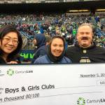 At the Nov. 5 Seattle Seahawks/Washington Redskins football game at CenturyLink Field, representatives with the Boys & Girls Clubs of the Olympic Peninsula accepted a $10,000 grant for technology. On the field for the event were, from left, Olivia Thai, resource development director for the Boys & Girls Clubs Washington State Association, Heidi OLeary, Sequim clubs Youth of the Year candidate, and Dave Miller, Sequim unit director. Submitted photo