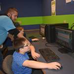 Recent grants from CenturyLink, the Seattle Seahawks, and First Federal Community Foundation, helps bring in new computers/tablets and pay for software at the Boys & Girls Clubs of the Olympic Peninsula in Sequim and Port Angeles to help staff like Nathaneal Windrich, computer room coordinator, help students like Cooper Sharpe, in back, and Warren Nichols use learning software like Stride Academy. Photo courtesy of the Boys & Girls Clubs of the Olympic Peninsula