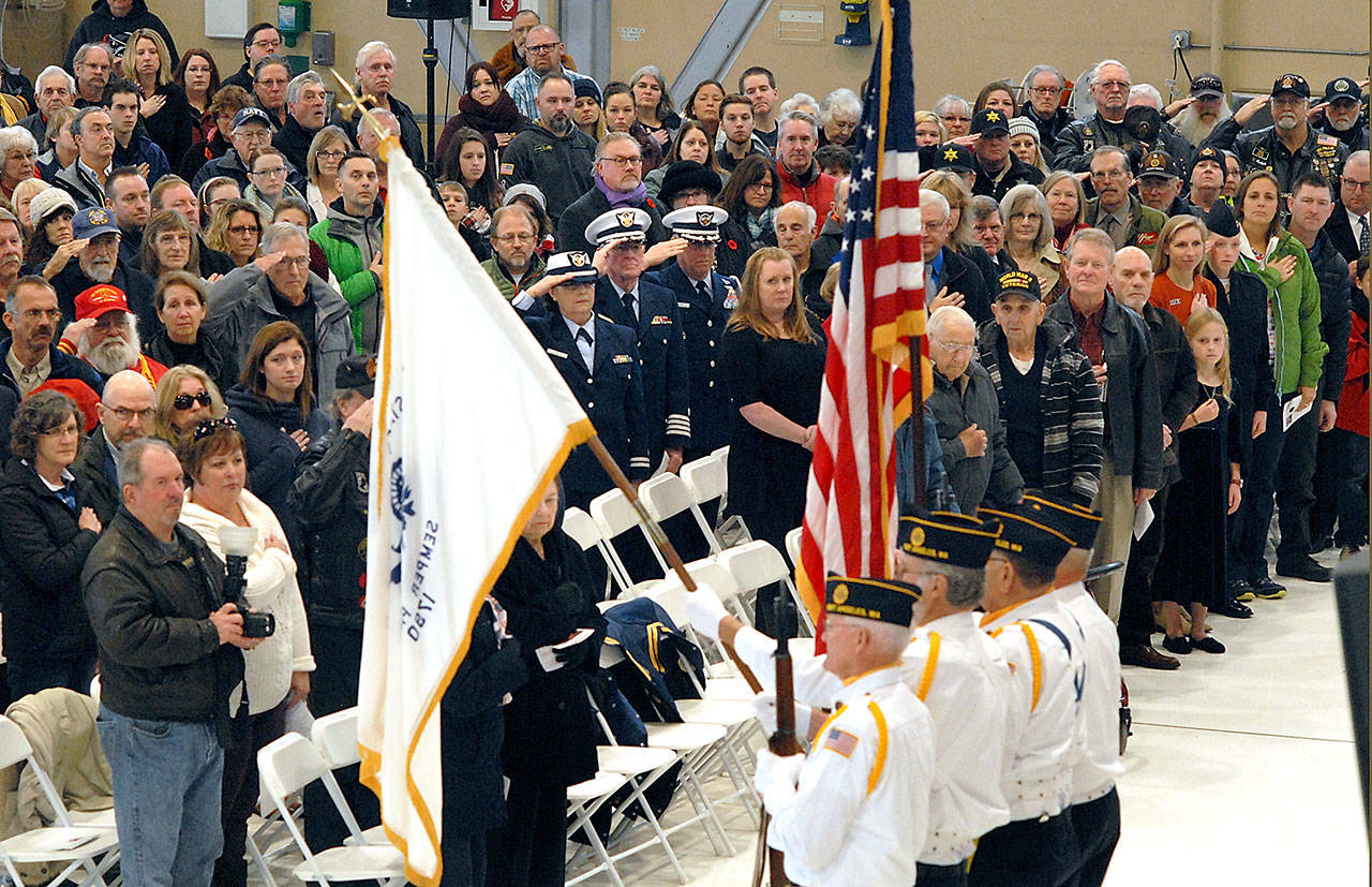 A color guard from American Legion Post 29 of Port Angeles presents the flags of the U.S. Coast Guard and of the United States at Saturdays Veterans Day Ceremony at the U.S. Coast Guard Air Station/Sector Field Office Port Angeles on Ediz Hook.