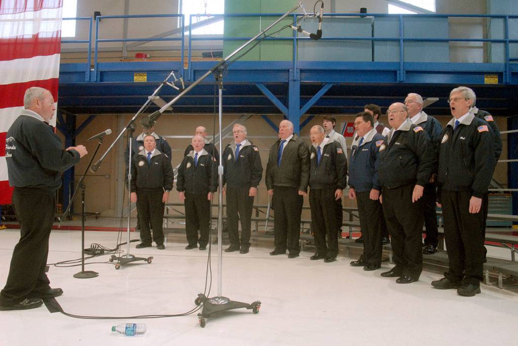 The Olympic Peninsula Mens Chorus, directed by Jim Davis, sings Youre a Grand Old Flag during Saturdays Veterans Day ceremony. (Keith Thorpe/Peninsula Daily News)