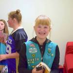 Girl Scout Sophie Morton smiles big while helping fellow scouts Taylor Heyting and Paige Krzyworz stock the new child-friendly space called Cozy Cove in the Sequim Police Department. Photo courtesy of Heidi Krzyworz