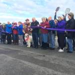 Sequim mayor Dennis Smith cuts the ribbon on the entrance to Carrie Blake Community Park on Nov. 20. The new road to the park finished on Oct. 30 and increases safety as it deters vehicle traffic away from playgrounds. Sequim Gazette photo by Matthew Nash