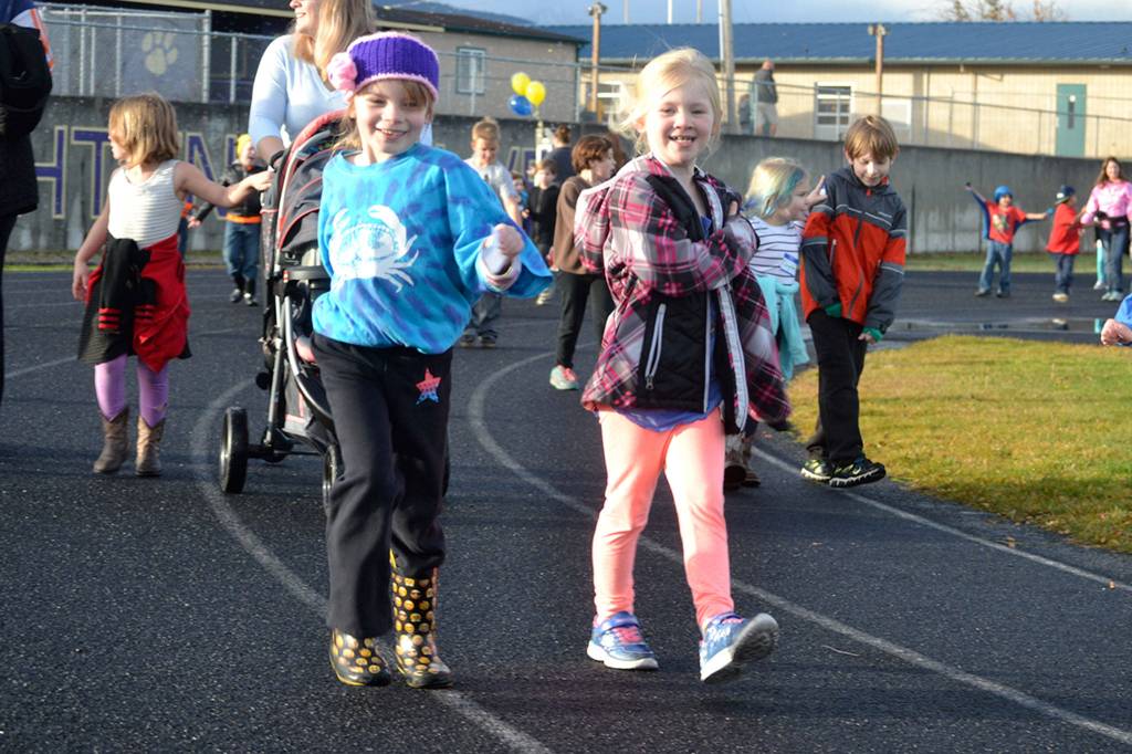 First graders Piper Jackson, left, and Madison Bell in Ione Marcys class keep a steady pace during the Turkey Trot. Sequim Gazette photo by Matthew Nash