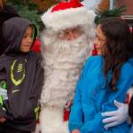 Santa Claus and Sequim Irrigation Festival Royalty greet Ian Klinger, 7, and Ahrya Klinger, 9, at Centennial Place in downtown Sequim on Nov. 25. Sequim Gazette photo by Erin Hawkins