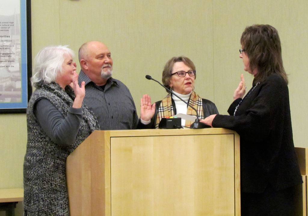 Sequim City Councilors, from left, Pam Leonard- Ray, John Miller, and Candace Pratt take the oath office in Jan. 2016 from Sequim city clerk Karen Kuznek-Reese. Miller died on Nov. 29, and Leonard-Ray said they will have a difficult time filling his shoes with someone with the same connections. Photo courtesy City of Sequim