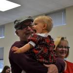 Mickey Aughtry of Sequim holds his granddaughter Maddie Aughtry, 1, after she got her photo taken with Mr. and Mrs. Santa Claus on Dec. 2. Sequim Gazette photo by Matthew Nash