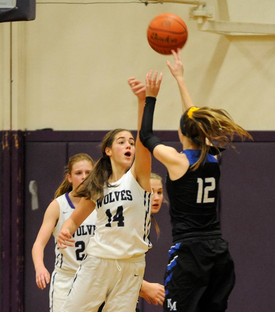 Sequims Hope Glasser looks to block North Mason forward Sophia Greens shot in the Wolves 57-36 win on Dec. 6. Glasser had 14 points and 10 rebounds in the victory. Sequim Gazette photo by Michael Dashiell