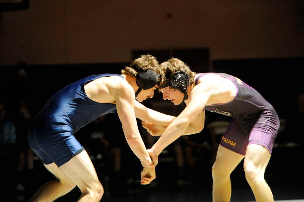 Bremertons Eddy Taylor, left, faces off with Sequims Hayden Gresli who went on to win 17-2 in the third period on Dec. 5. Gresli led 7-1 in the first period and 12-2 in the second before finishing with a takedown for the tech fall.