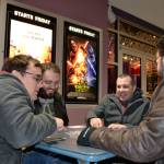 Friends, from left, Jesse Reynolds, Ryan French, Mike French and Ken Smith with Benjamin Komar (not pictured) play card games waiting for the 3-D showing of Star Wars Episode VII: The Force Awakens on opening night, Thursday, Dec. 17, 2015. Some of the sounds from the original films come from animals formerly living in Sequim. Sequim Gazette photo by Matthew Nash