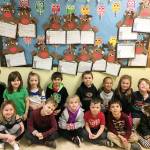 Students in Elizabeth Halls class at Helen Haller Elementary School show off their research project about reindeer. Submitted photo