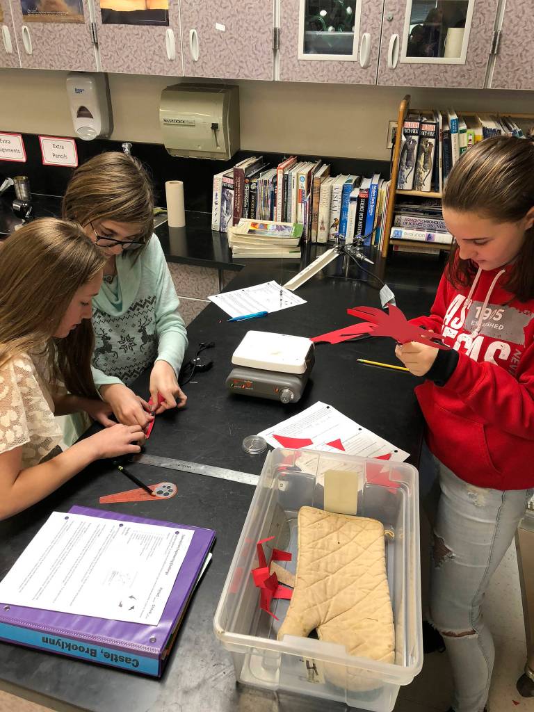 From left, Brooklynn Castle, Lexi Treece and Jenna Finley  students at Sequim Middle School  work to devise a fan blade assembly during the schools Convection Engineering Challenge. Submitted photo