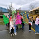 Greywolf Elementary School fifth-graders Alexia Constant and Chloe Tweeter show off their pink Christmas tree before heading with fellow fifth-graders to Avamere Olympic Rehabilitation of Sequim on Dec. 15. Students helped decorate and bring Christmas carols to the facilitys residents. Submitted photo