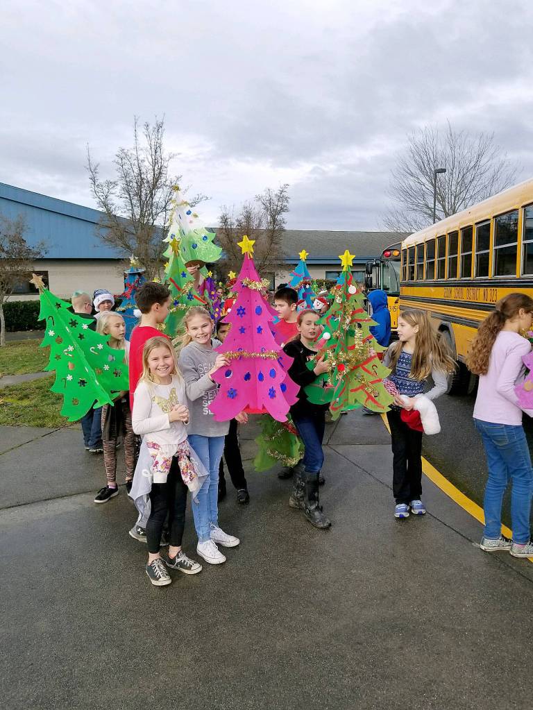 Greywolf Elementary School fifth-graders Alexia Constant and Chloe Tweeter show off their pink Christmas tree before heading with fellow fifth-graders to Avamere Olympic Rehabilitation of Sequim on Dec. 15. Students helped decorate and bring Christmas carols to the facilitys residents. Submitted photo