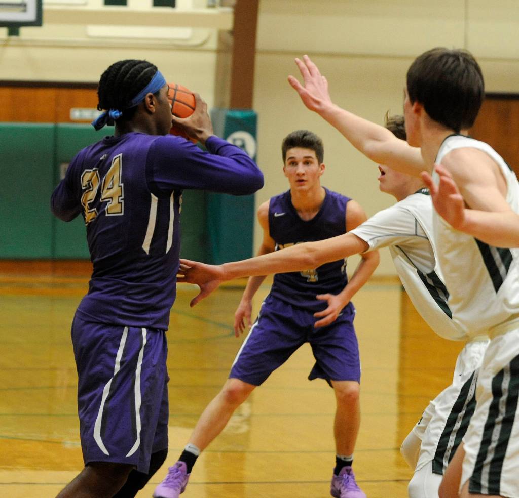 Sequims Keeshawn Whitney, left, and Nate Despan look to break Port Angeles defense down in a Dec. 13 league match-up. Sequim Gazette photo by Michael Dashiell