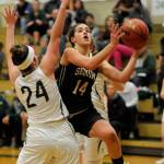 Sequims Hope Glasser, right, drives past Port Angeles defender Aeverie Politika for a basket in Sequims 44-17 loss to the host Roughriders on Dec. 13. Sequim Gazette photo by Michael Dashiell