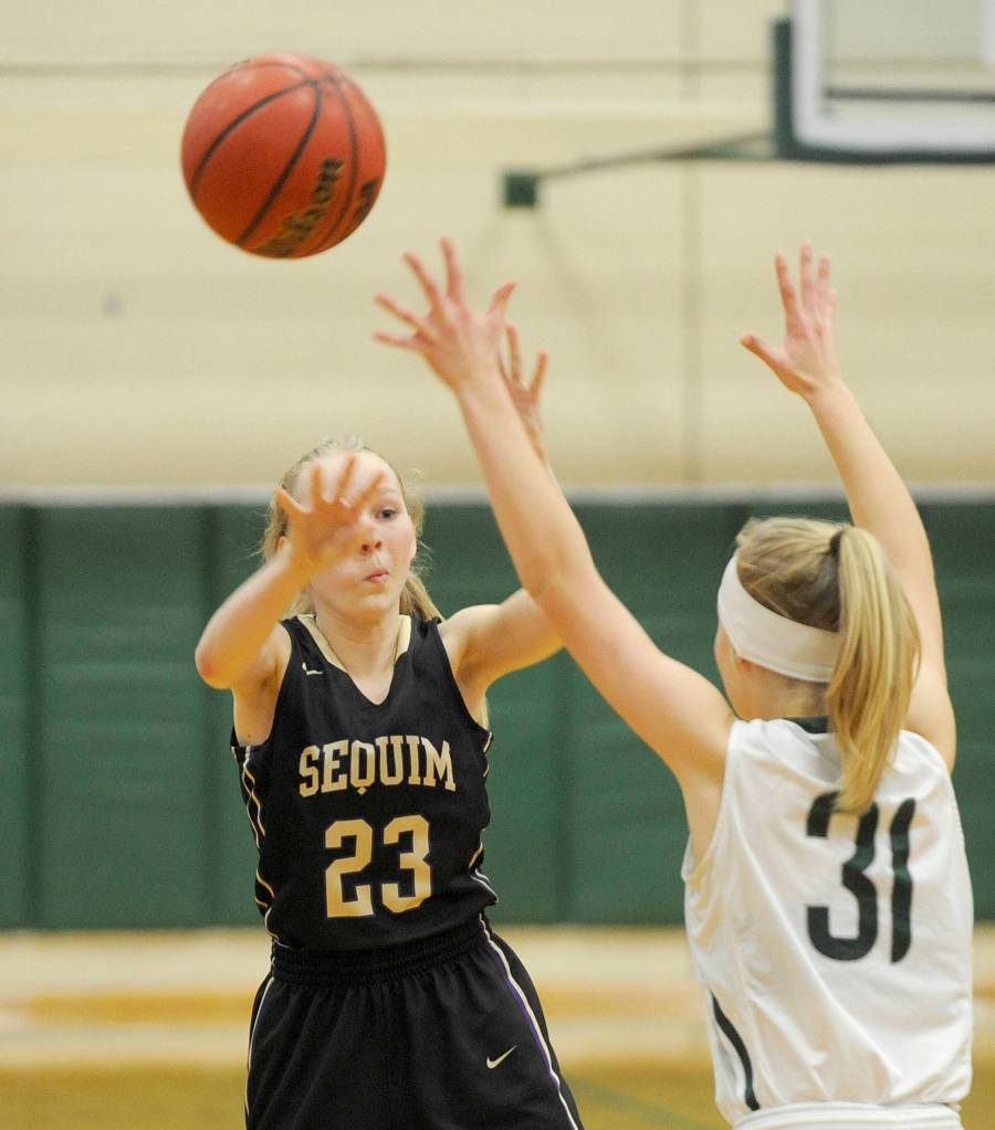 Sequims Melissa Porter,left, passes to a teammate as Port Angeles Summer Olsen defends. Sequim Gazette photo by Michael Dashiell