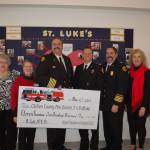 The Sequim-Dungeness Hospital Guild donated more than $11,000 to Clallam County Fire District 3 at the Guilds annual appreciation luncheon on Dec. 12. Guild members Anna Gregory, left, and Debbie Kahle stand with Fire Chief Ben Andrews, Capt. Derrell Sharp, Assistant Chief Tony Hudson, Guild president Jean Janis and Nancy McGovern at St. Lukes Episcopal Church. Sequim Gazette photo by Erin Hawkins