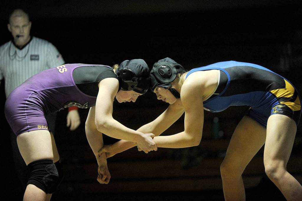 Sequims Kiara Pierson battles Bremertons Haley Michaelson at the Olympic League Girls Dual Meet on Dec. 14. They were deadlocked with no points through the third period until the match ended on an injury after Pierson attempted to take down Michaelson and the Bremerton wrestler landed on her thumb and injured it. Sequim Gazette photo by Matthew Nash