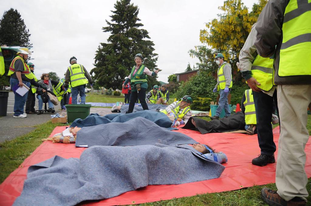 Community Emergency Response Team members treat victims of an earthquake during a June 3 drill. In 2017, about 300 Sequim area residents joined the CERT program and fire officials with Clallam County Fire District 3 hope to get hundreds more in the coming year. Sequim Gazette file photo by Michael Dashiell