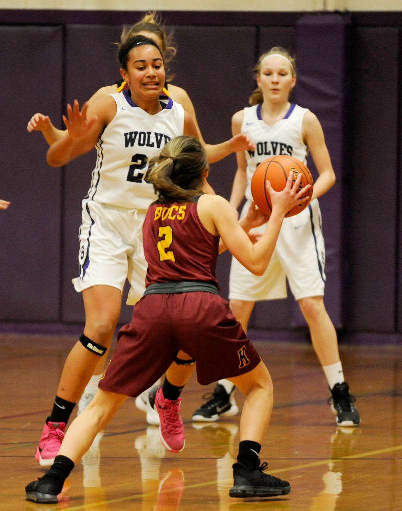 Sequim forward Jayla Julmist (20) keeps an eye on Kingston guard Kylee Walker as Sequims Melissa Porter looks on. Sequim Gazette photo by Michael Dashiell