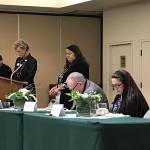 Leaders with the Sequim-Dungeness Valley Chamber of Commerce, from left, past president Nell Clausen, Executive Director Shelli Robb-Kahler, Kevin Hoult, with the North Peninsula Small Business Development Council and Lisa Dudley bow their heads and close their eyes for a moment of silence for retired employee Jeri Smith on Jan. 9 at the Chamber luncheon. Sequim Gazette photo by Erin Hawkins