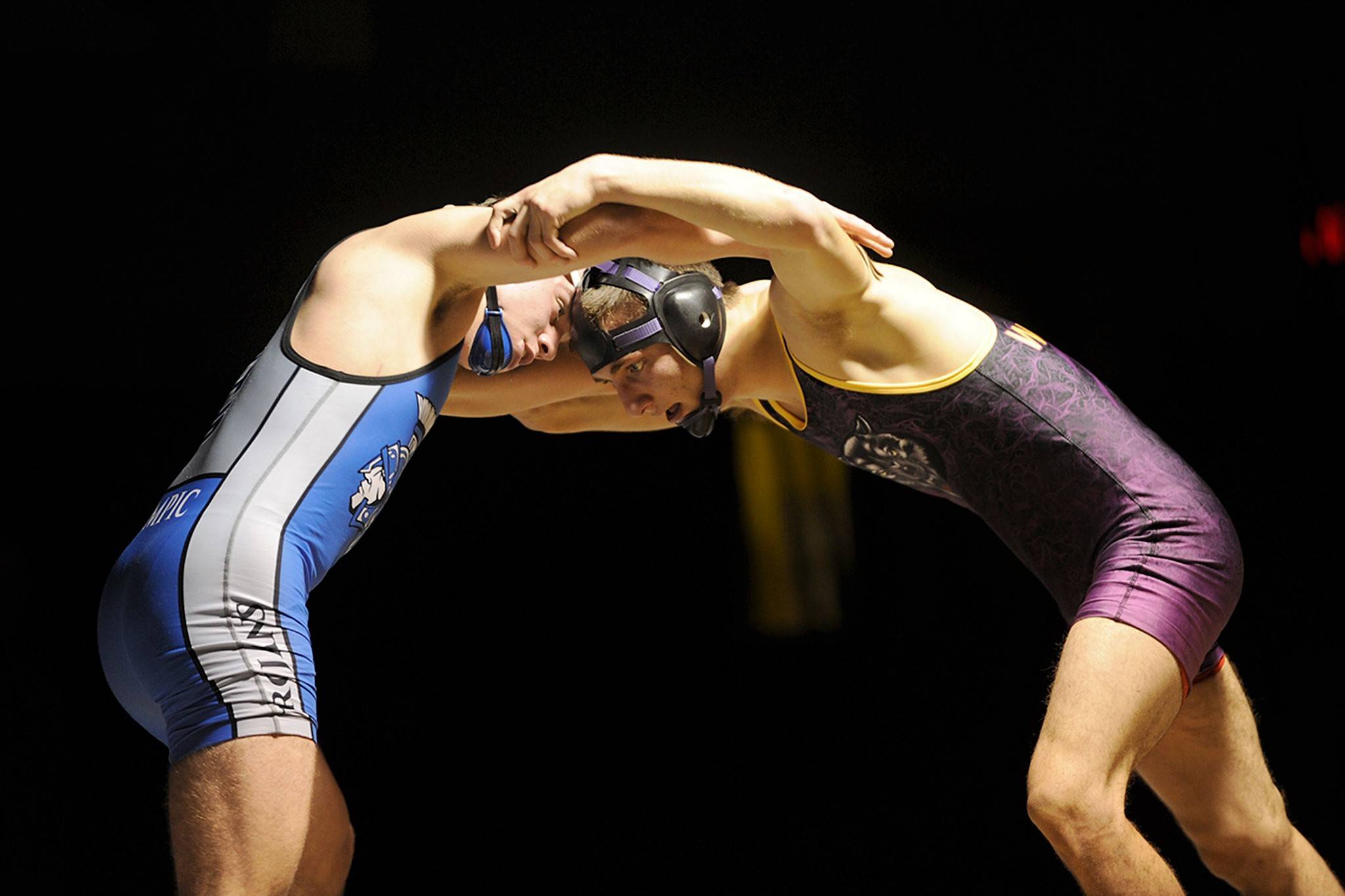 Olympics Taylor Andrews, left, and Sequims Chris Puksta had a close match on Jan. 11 with Puksta coming close to a pin in the second period and narrowing his deficit to 9-7. Andrews pulled ahead in the third period though and won 12-7. Sequim Gazette photo by Matthew Nash