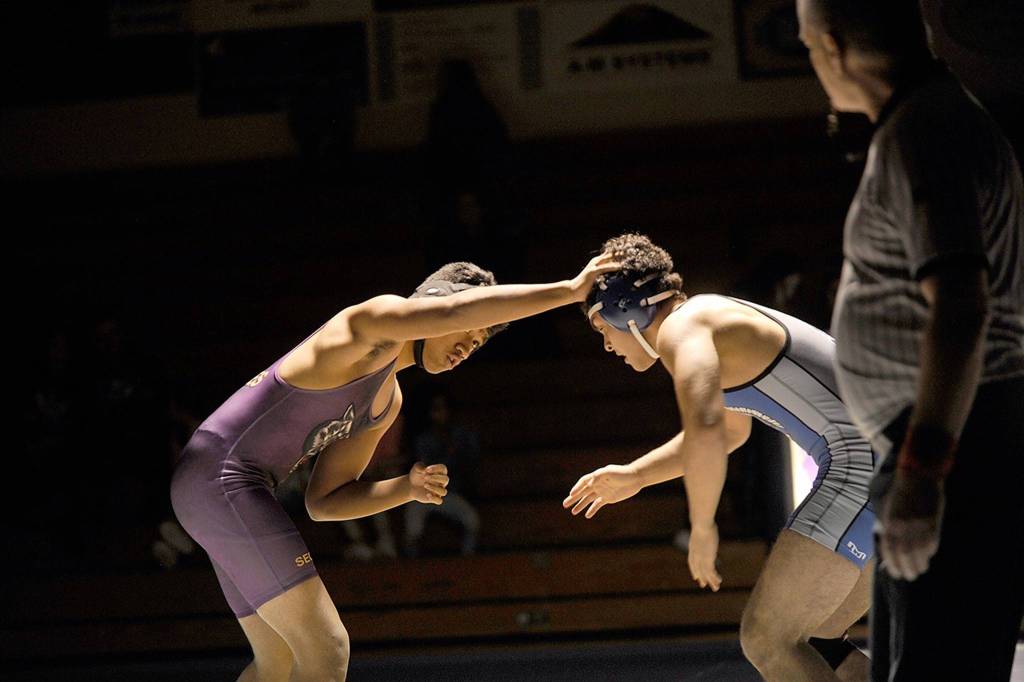Sequims Amaran Sauiluma fends off Olympics Courtney Santos on Jan. 11. Santos went on to pin Santos in 2:28. Sequim Gazette photo by Matthew Nash