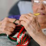 Phyllis Peashka says she taught herself to crochet. She figures she makes at least one hat, scarf or potholder per day. My hands cramp up, but I keep going. Sequim Gazette photo by Michael Dashiell