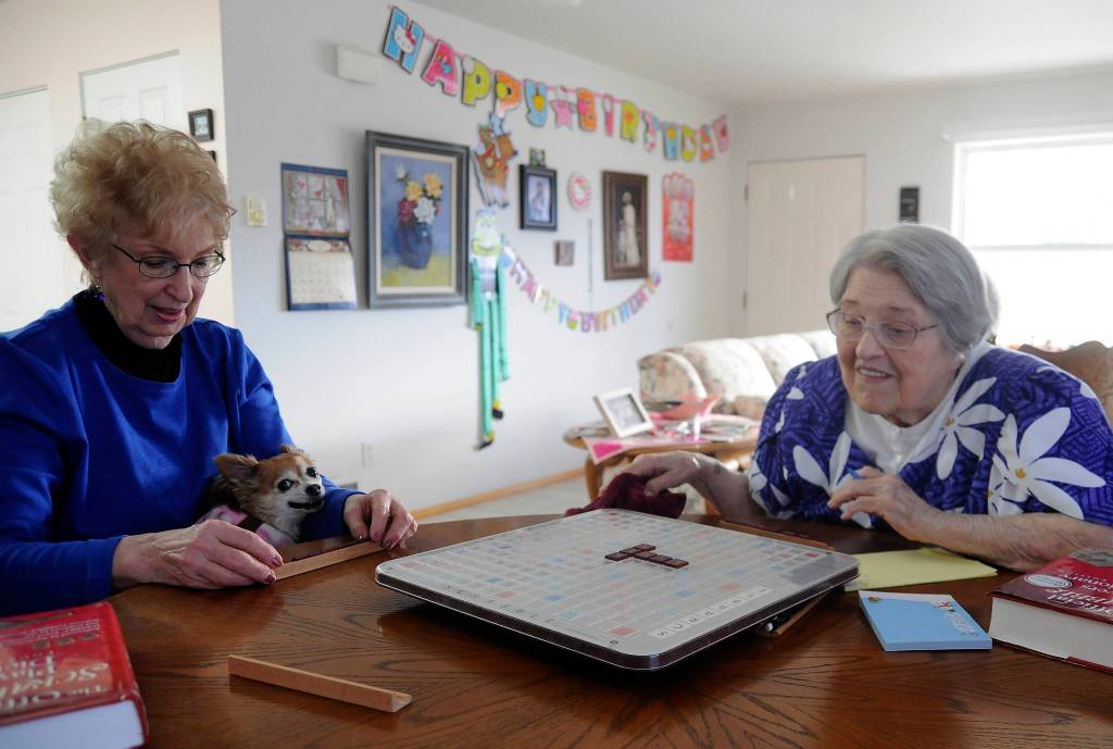 Sally Harris-Crawford and Phyllis Peashka start one of their weekly Scrabble games last week. Peashka recently turned 96. Sequim Gazette photo by Michael Dashiell