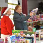 Lori Seimer of Sequim, on right, looks at toys for her children with volunteer Anne Notman of Sequim Community Aid at Toys for Sequim Kids on Dec. 13. Sequim Gazette photo by Matthew Nash