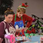 Colleen OBrien of Sequim considers some toys for her three children with help from volunteer Phyllis Newland at Sequim Community Aids Toys for Sequim Kids on Dec. 13. Sequim Gazette photo by Matthew Nash
