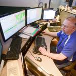 JeffCom Dispatcher Terry Taylor handles a call Tuesday amid a report of a possible capsized boat near the Hood Canal bridge. Calls from that area are frequently routed to the incorrect dispatch center. Photo by Jesse Major/Peninsula Daily News