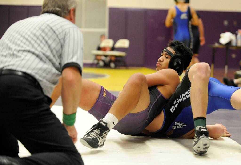 Sequim freshman Amaran Sauiluma works for a pin late against North Masons Josh Raymond in the 185-pound weight division at Saturdays All-Comers prep wrestling tournament in Sequim. Sauiluma was down 5-3 late before picking up the victory by pin.