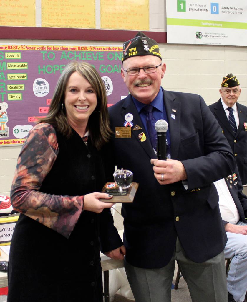 Rod Lee, Quartermaster for the Carlsborg VFW Post 4760, presents Greywolf Elementary School teacher Alex Ogilvie with the Smart/Maher VFW Teacher of the Year Award. Photo by Darcy Lamb