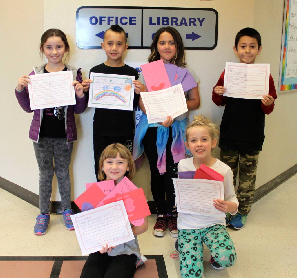 Students from Kimberly Knudsons second-grade class display some of Greywolf Elementary Schools Operation Valentine creations. They are (back row, from left) Isabella Loftin, Alexander Alokoa, Madeline Niemeyer and Isaac Edgecombe, with (front row, from left) Makenzi Seimer and Kaiya Robinson. Photo by Darcy Lamb