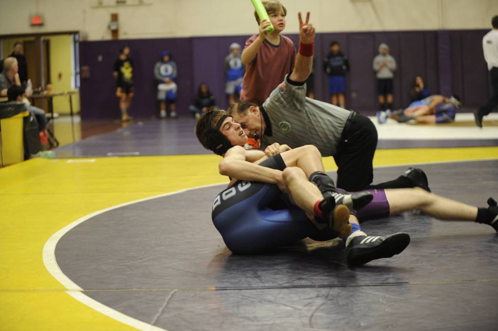 Sequim senior Garrett Harris, a first-year wrestler, pins North Mason Jimmy Burch in the last second of the second round at sub-regionals. Harris went on to become an alternate to regionals with a fifth place finish. Sequim coach Bill Schroepfer said he told players that everything before February was practice and that the season started now. Sequim Gazette photo by Matthew Nash