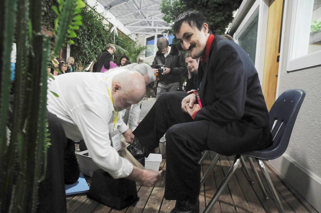 David Staus, right gets his shoes shined for a night of dancing, thanks to some help from Larry Hurd.