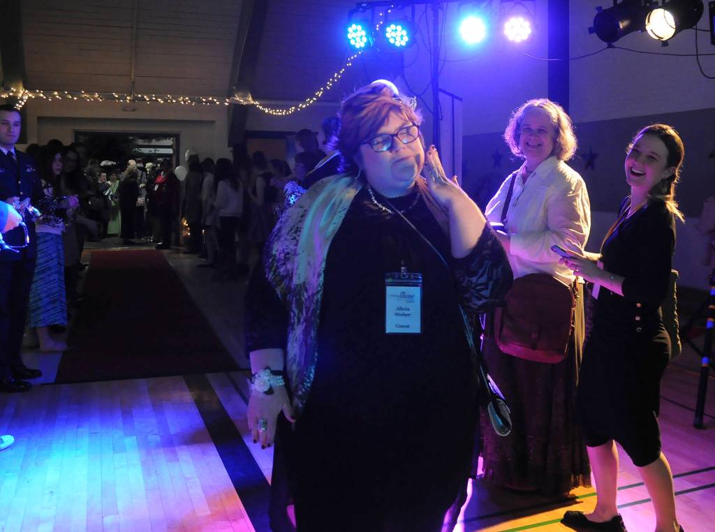 Alicia Stuber of Sequim poses for photos after receiving her tiara at the Feb. 9 Night to Shine event, as Catherine Walker McKinney of Clallam Mosaic and Tiffany Malean, special education teacher at Helen Haller Elementary School, look on. Sequim Gazette photo by Michael Dashiell