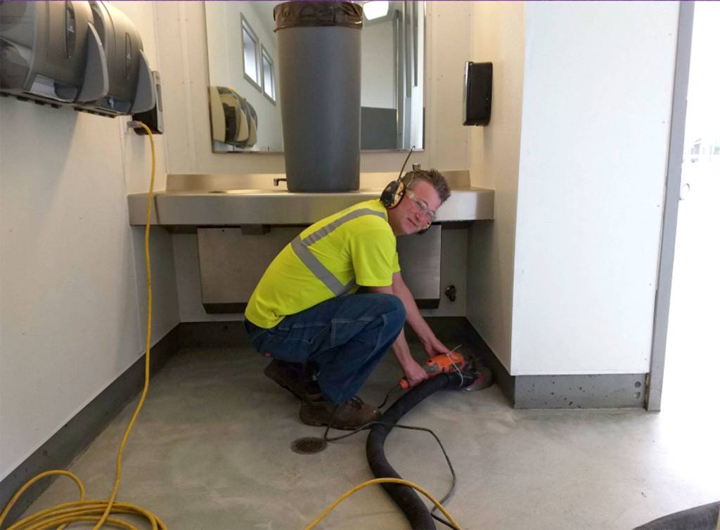 Gary Butler with the City of Sequim works on refurbishing one of the citys public bathrooms. City staff recently remodeled them to make it easier to clean daily and remove vandalism. Photo courtesy City of Sequim