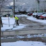 Gary Butler, a City of Sequim maintenance worker, clears a driveway near the Sequim Civic Center after snowfall in 2017. Road crew administrators say the worst spots to travel in the city include hilltop areas such as South Third Avenue, Miller Road and Whitefeather Way. Photo courtesy of the City of Sequim
