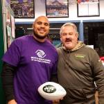 New York Jets defensive end Xavier Cooper stands with Dave Miller, Sequim Boys & Girls Club unit director, on Feb. 16, while visiting with club members about anti-bullying campaign. Photo courtesy of the Boys & Girls Club of the Olympic Peninsula