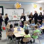 Sequim High School FFA members (from left) Makenzie Campbell, Natalie Thurston, Victoria Lelle, Brittany Jensen, Noah King, Abby Garcia, Evan King and Abel Lelle visit Leigh Ann Knudsons second-grade class at Greywolf Elementary School in February. Photo by Darcy Lamb