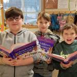 Korey Apley, Kayden Disinski and Ryan Spelker  fourth-grade students in Patrick Carons class at Helen Haller Elementary School  check out their new dictionaries, courtesy of Rotary Club of Sequim. Submitted photo