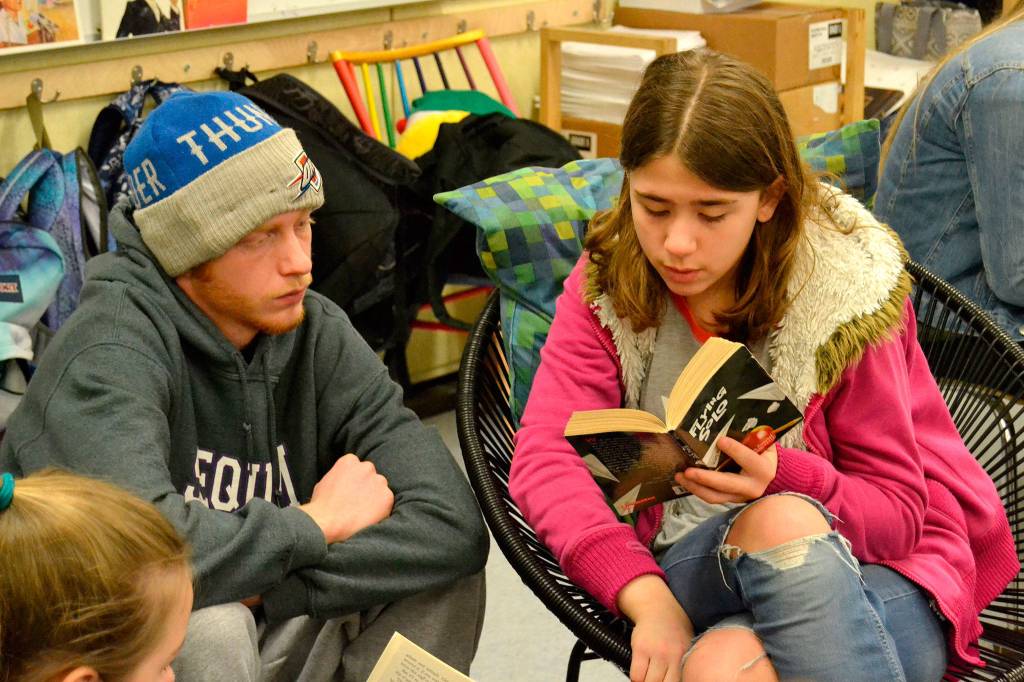 Sierra Lomker of Meredith Vincents fifth grade class reads to high schooler John Stipe for Read Across America Day on March 2. Students from both Sequim High School and Sequim Middle School traveled to Sequims elementary schools to read with younger students. Sequim Gazette photo by Matthew Nash