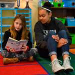 Third grader Glenna Krieger in Emily Ellefsons class reads to Sequim High School Jayla Julmist at Helen Haller Elementary for Read Across America Day. Sequim schools have participated in the event for a number of years. Sequim Gazette photo by Matthew Nash