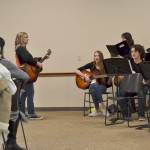 DeeDee Nielsen, instructional coach at Olympic Peninsula Academy, leads Olympic Peninsula Academy students in a song at OlyCAPs appreciation luncheon on March 8 for volunteers ages 52 and up. Students in the intermediate guitar class, choir, and upcoming Mary Poppins Jr production sang and performed several songs for the crowd.