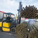 Lucas Dailey, warehouse worker at Leitz Farms in Port Angeles, uses a forklift to stack posts at the store Monday. (Jesse Major/Peninsula Daily News)
