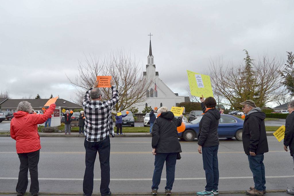 More than 20 parishioners of St. Lukes Episcopal Church stand along North Fifth Avenue on March 14 advocating for stricter gun laws. Church Deacon Diane Moore said more than 70 people from the church who could not be in attendance signed a billboard in support of The National School Walkout too. Sequim Gazette photo by Matthew Nash
